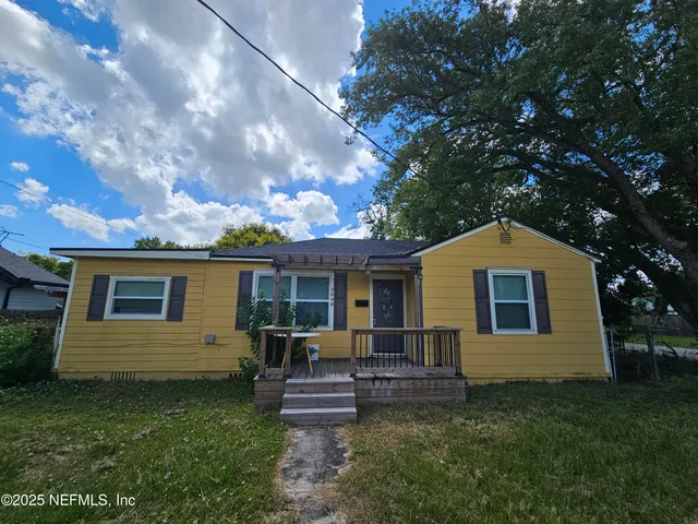 a backyard of a house with table and chairs