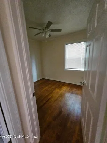 a view of a room with wooden floor and cabinet