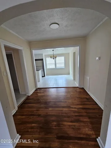 a view of an empty room and wooden floor