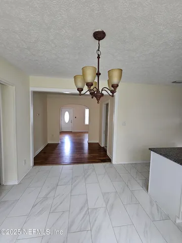 a view of a hallway with a chandelier