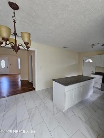 a kitchen with stainless steel appliances a sink stove and cabinets