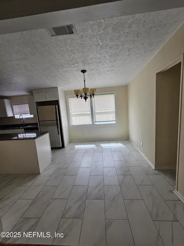 a view of a refrigerator in a kitchen