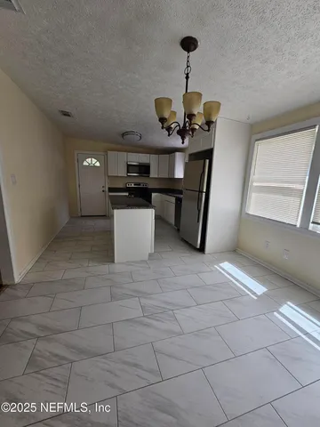 a kitchen with a sink and chandelier