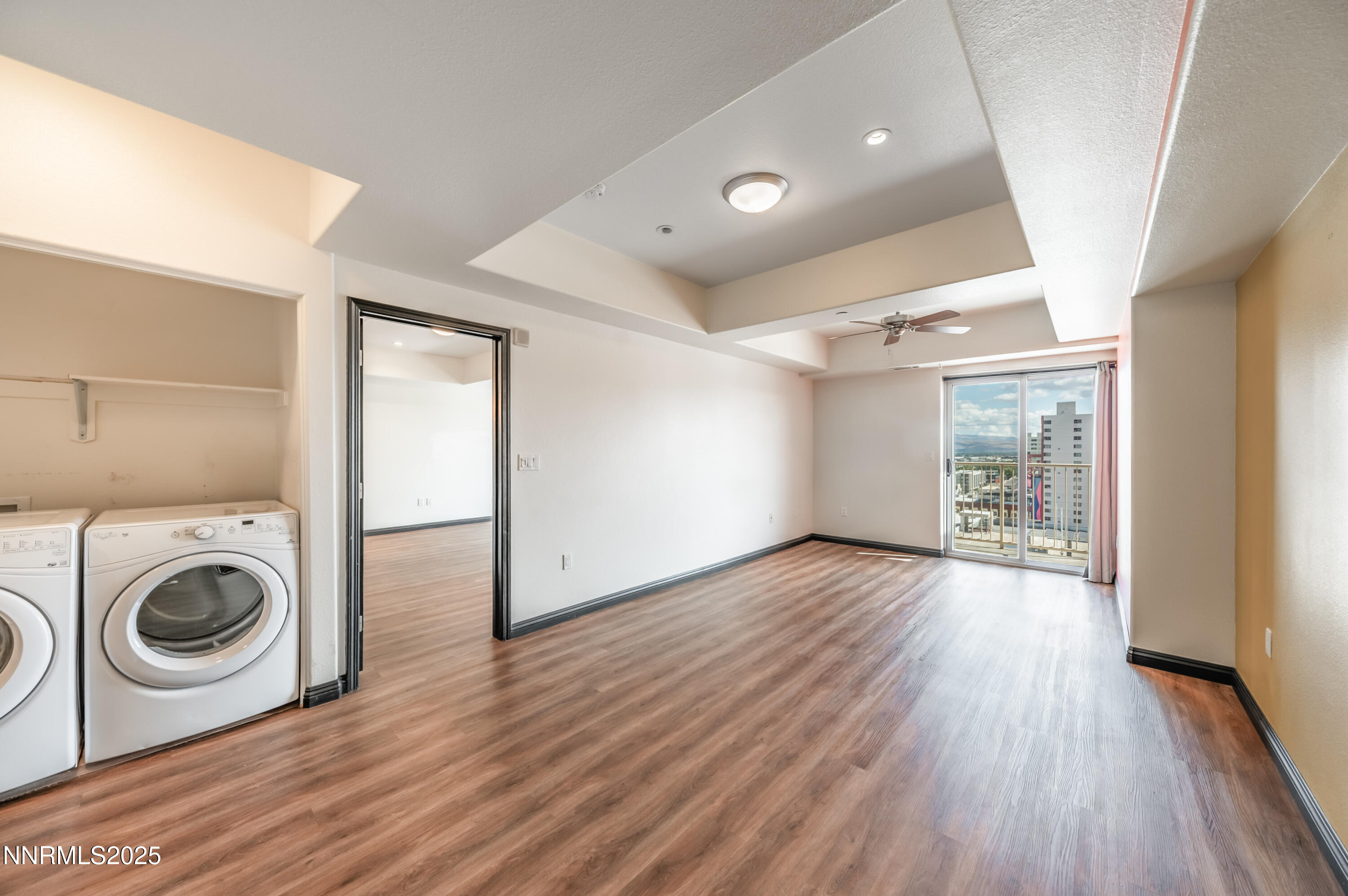200 West 2nd Street, Unit 1101 Reno, NV 89501 - Photo 14 of 38 a view of a big room with wooden floor washing machine and dryer