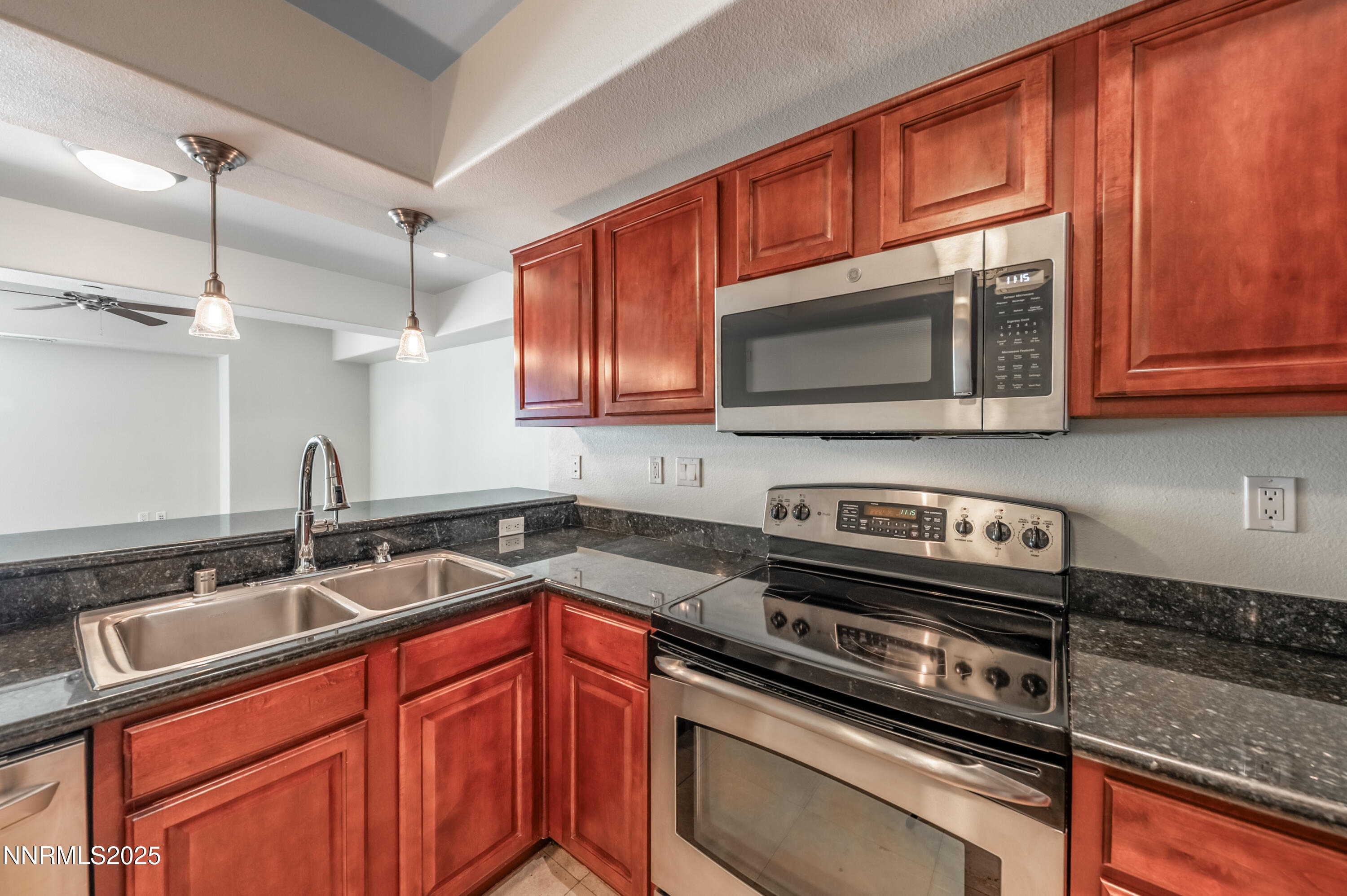 200 West 2nd Street, Unit 1101 Reno, NV 89501 - Photo 5 of 38 a kitchen with stainless steel appliances granite countertop a sink stove and microwave