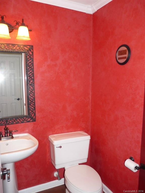 1115 Hess Road Concord, NC 28025 - Photo 11 of 21 a bathroom with a toilet a sink and mirror
