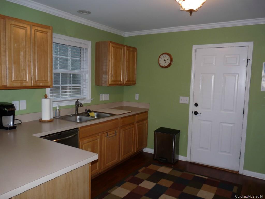 1115 Hess Road Concord, NC 28025 - Photo 13 of 21 a kitchen with stainless steel appliances granite countertop a sink a stove and a refrigerator