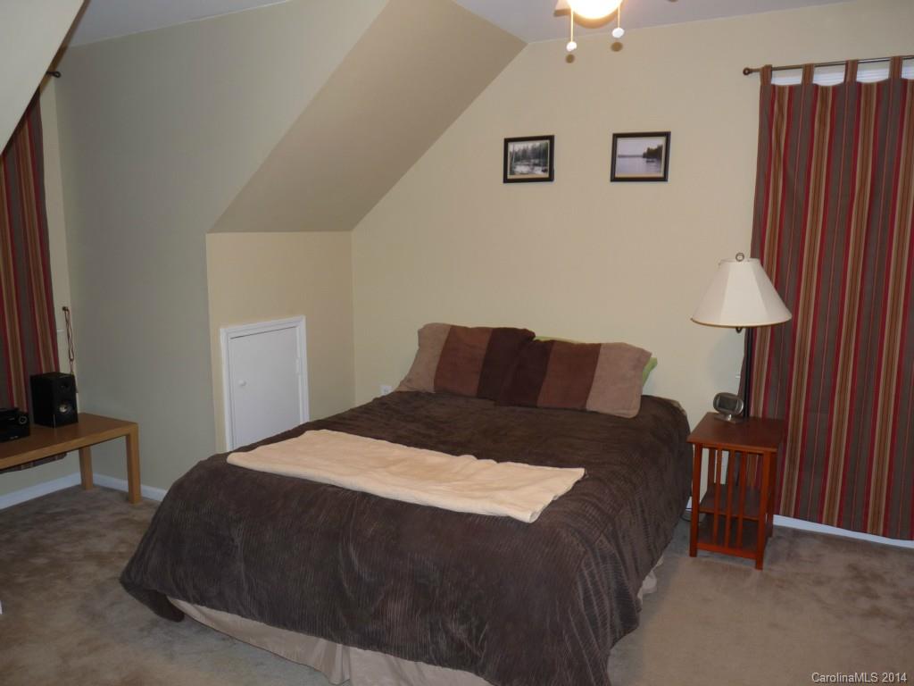 1115 Hess Road Concord, NC 28025 - Photo 14 of 21 a bedroom with a bed and a lamp on dresser