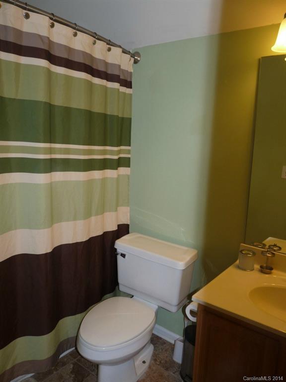 1115 Hess Road Concord, NC 28025 - Photo 15 of 21 a white toilet sitting next to a bathroom sink and vanity