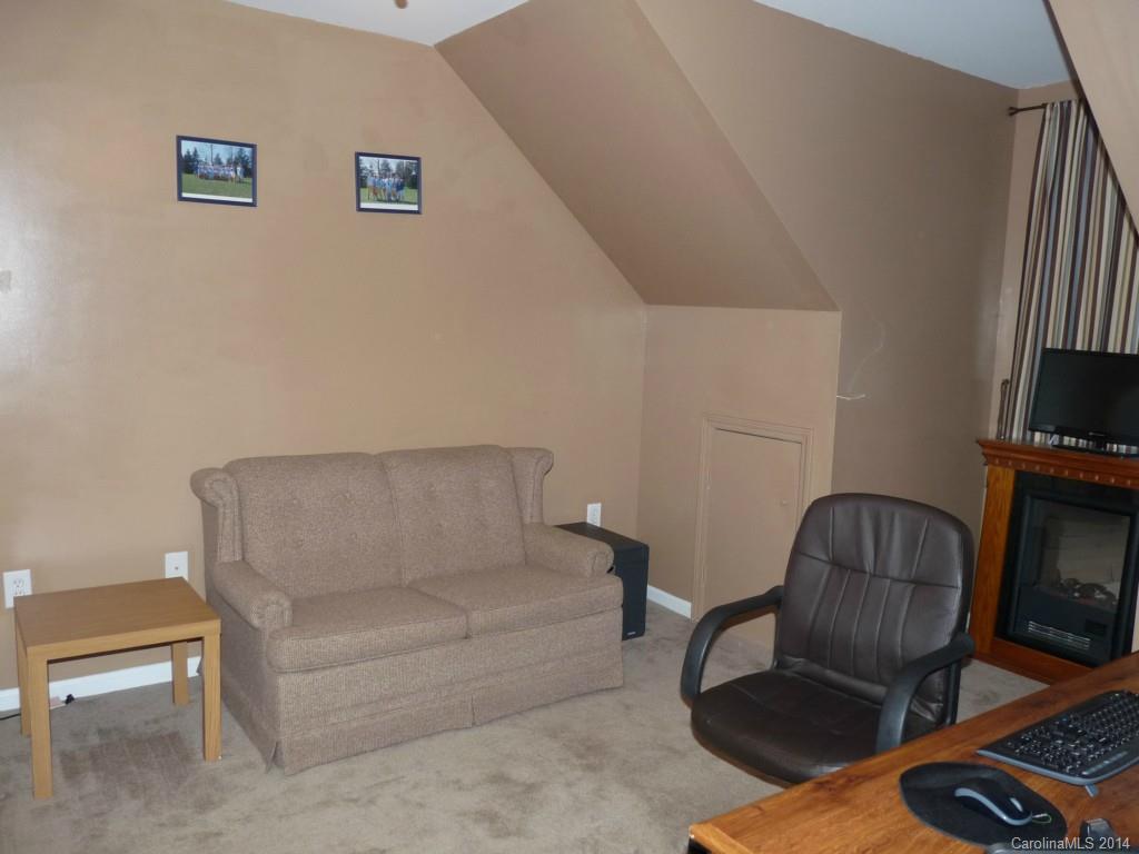1115 Hess Road Concord, NC 28025 - Photo 16 of 21 a living room with furniture a couch and a flat screen tv