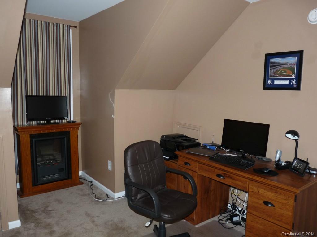 1115 Hess Road Concord, NC 28025 - Photo 17 of 21 a view of a workspace with furniture and a fireplace