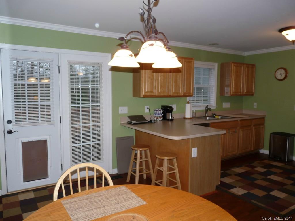 1115 Hess Road Concord, NC 28025 - Photo 6 of 21 a kitchen with stainless steel appliances granite countertop a sink a stove a refrigerator cabinets and a dining table