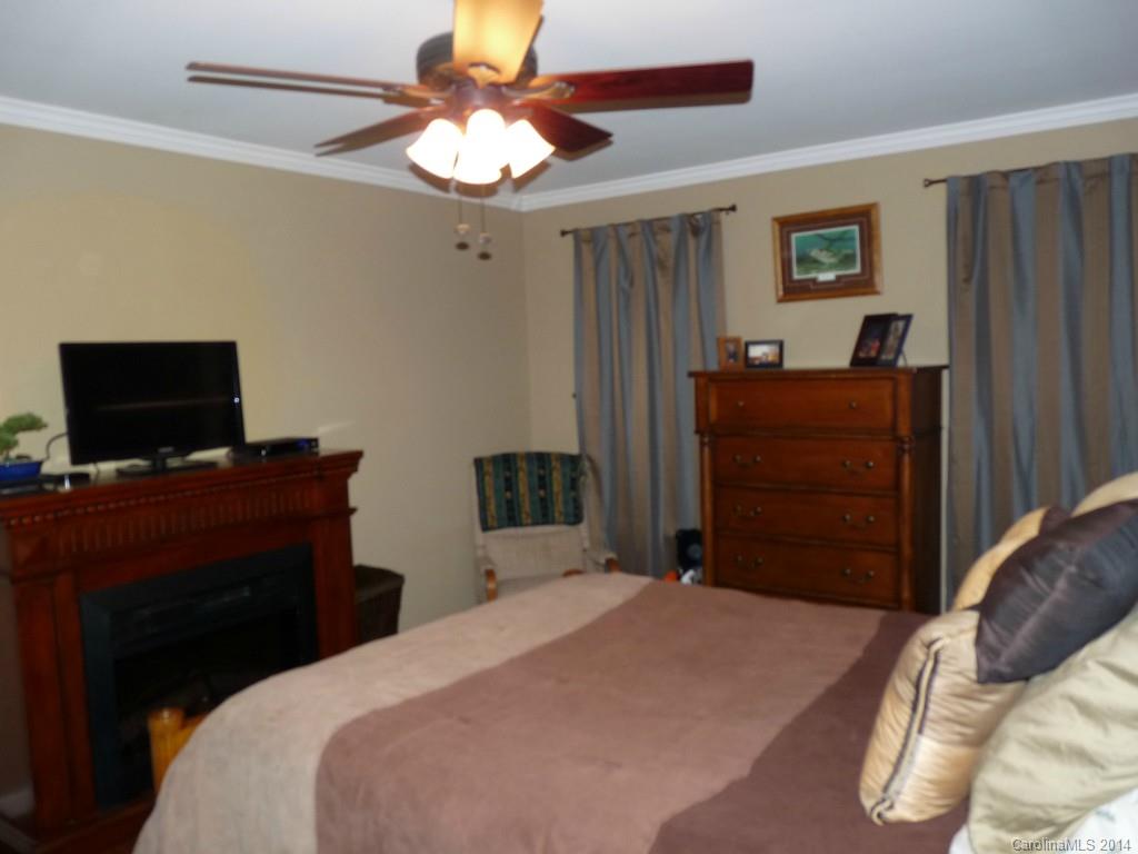 1115 Hess Road Concord, NC 28025 - Photo 9 of 21 a bedroom with a bed and a flat screen tv