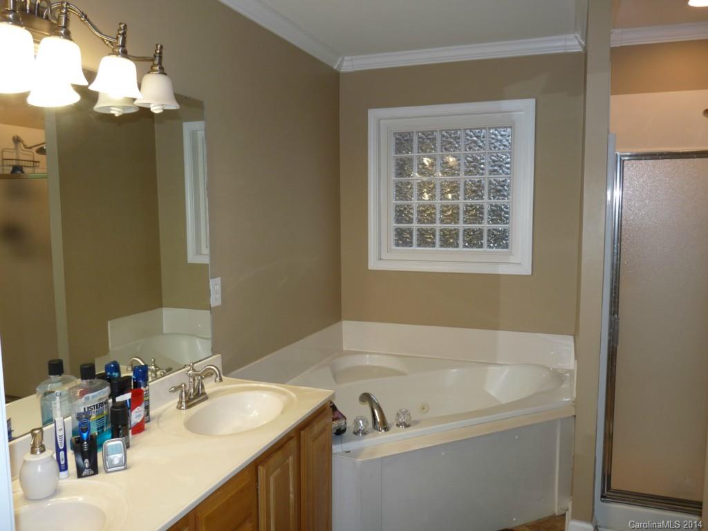 1115 Hess Road Concord, NC 28025 - Photo 10 of 21 a bath tub sitting next to a bathroom sink