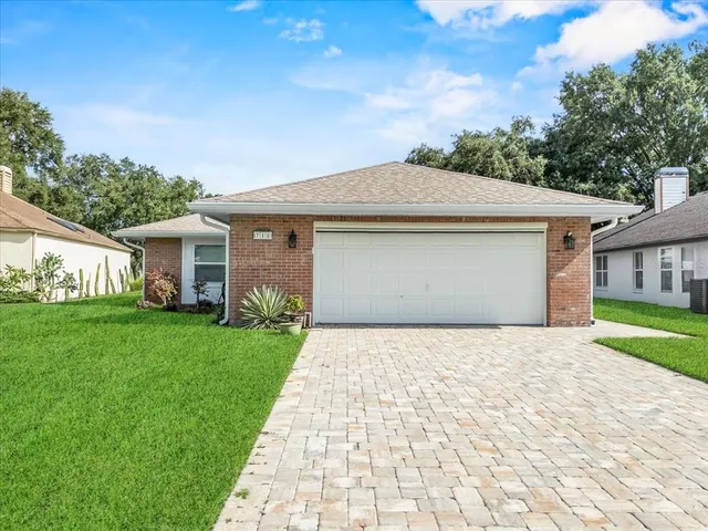 a front view of a house with a yard and garage