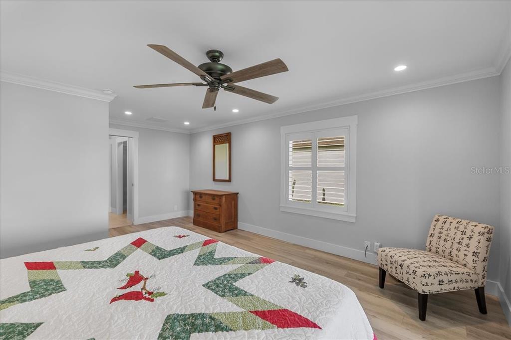 718 Canberra Road Winter Haven, FL 33884 - Photo 12 of 36 a bedroom with a bed and a chair