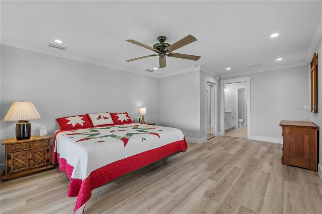 718 Canberra Road Winter Haven, FL 33884 - Photo 13 of 36 a bedroom with a bed and a chandelier