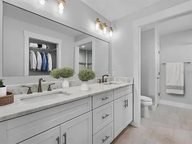 a bathroom with a double vanity sink and a mirror