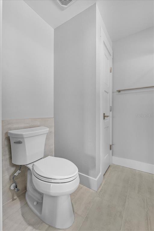 718 Canberra Road Winter Haven, FL 33884 - Photo 17 of 36 a white toilet sitting next to a shower