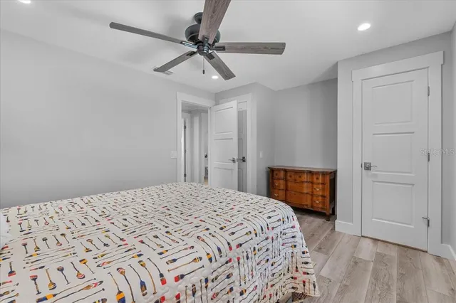 a bedroom with a large bed and a chandelier