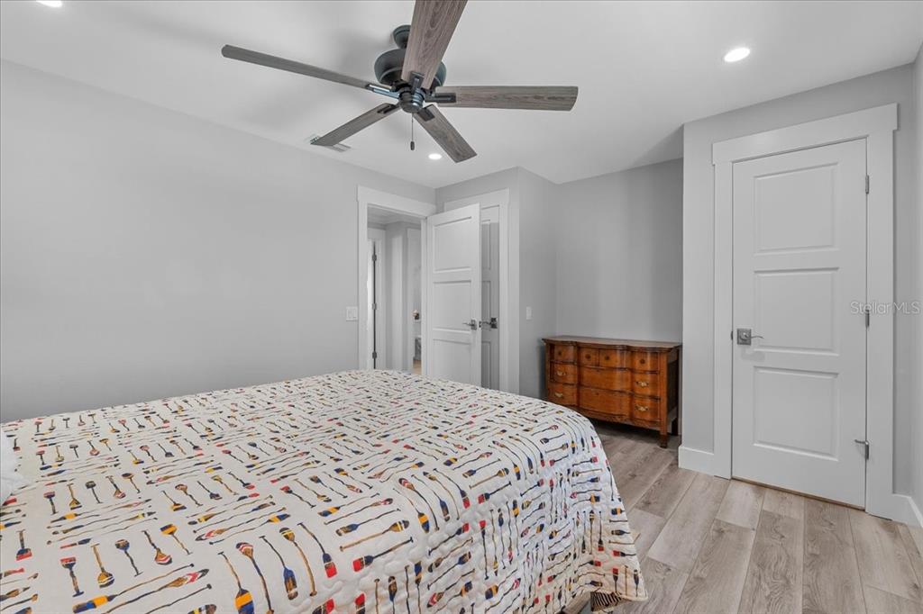 718 Canberra Road Winter Haven, FL 33884 - Photo 19 of 36 a bedroom with a large bed and a chandelier