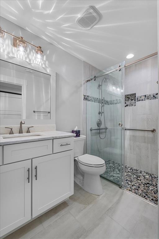 718 Canberra Road Winter Haven, FL 33884 - Photo 21 of 36 a bathroom with a sink a toilet and shower