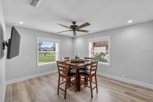 a view of a dining room with furniture and a window