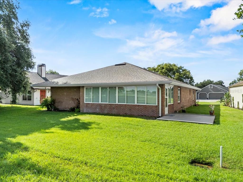 718 Canberra Road Winter Haven, FL 33884 - Photo 26 of 36 a view of a house with a yard and sitting area