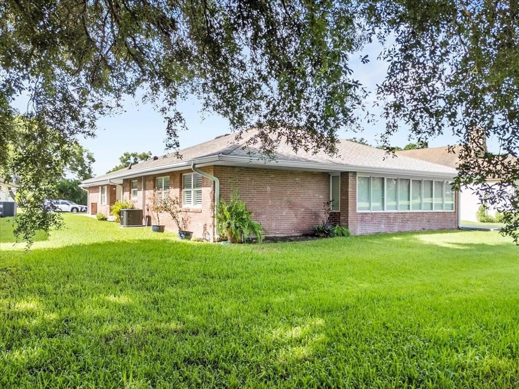 718 Canberra Road Winter Haven, FL 33884 - Photo 28 of 36 a view of a house with a yard and large trees