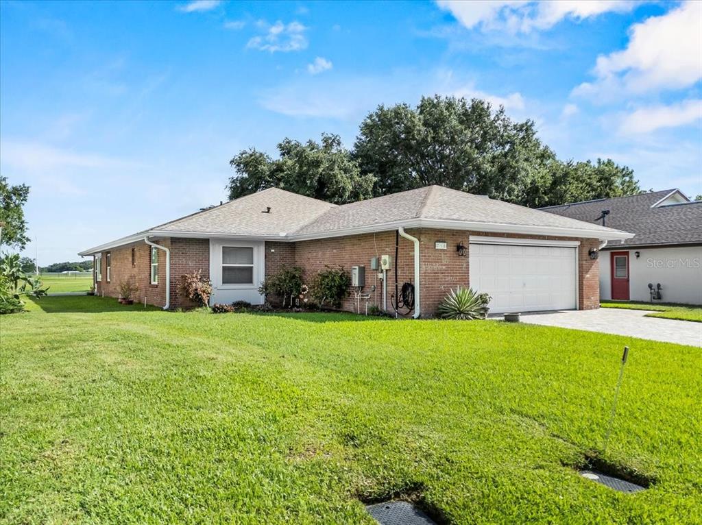 718 Canberra Road Winter Haven, FL 33884 - Photo 29 of 36 a front view of a house with a yard and trees