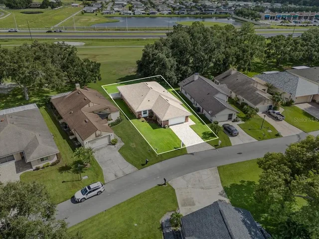 an aerial view of a house with a lake view