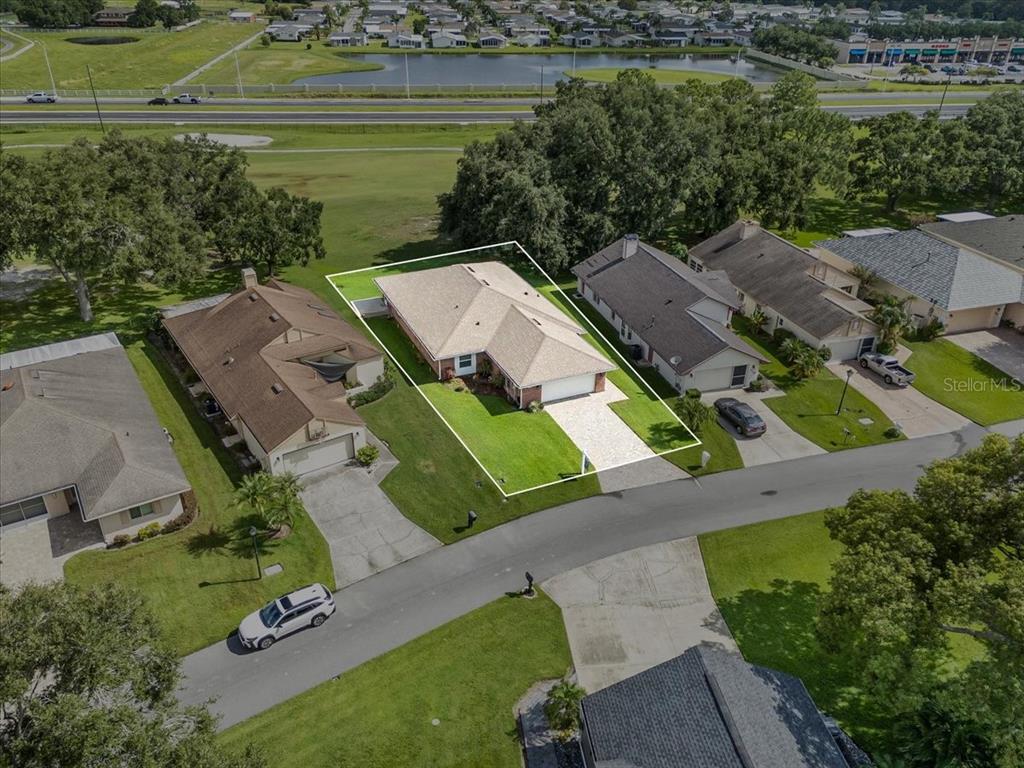 718 Canberra Road Winter Haven, FL 33884 - Photo 32 of 36 an aerial view of a house with a lake view