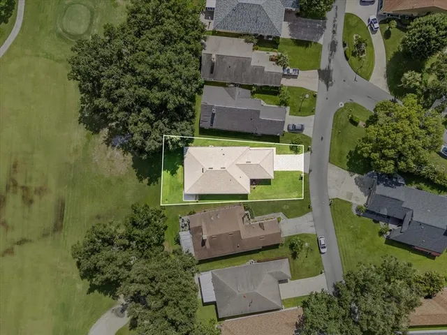 an aerial view of a residential houses with outdoor space and street view
