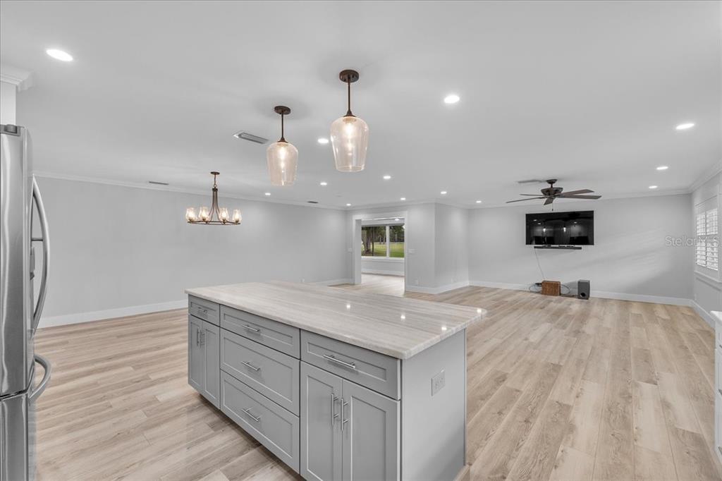 718 Canberra Road Winter Haven, FL 33884 - Photo 9 of 36 a kitchen with a sink and a refrigerator