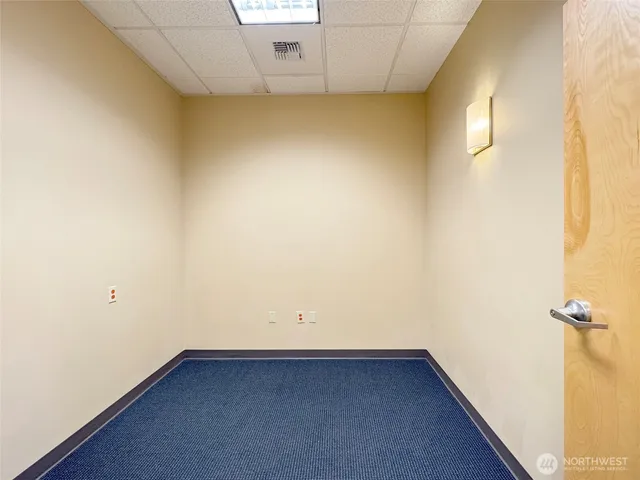 a room with wooden floor and cabinet
