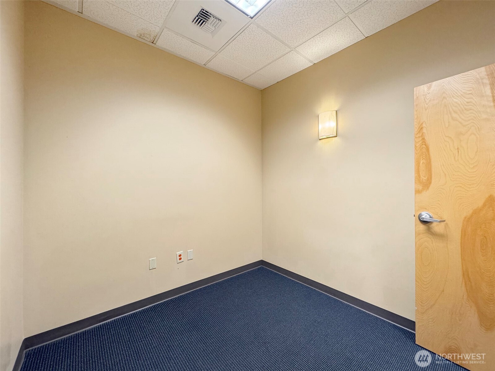1400 West Washington Street, Unit 102 Sequim, WA 98382 - Photo 21 of 35 an empty room with a wooden space and windows