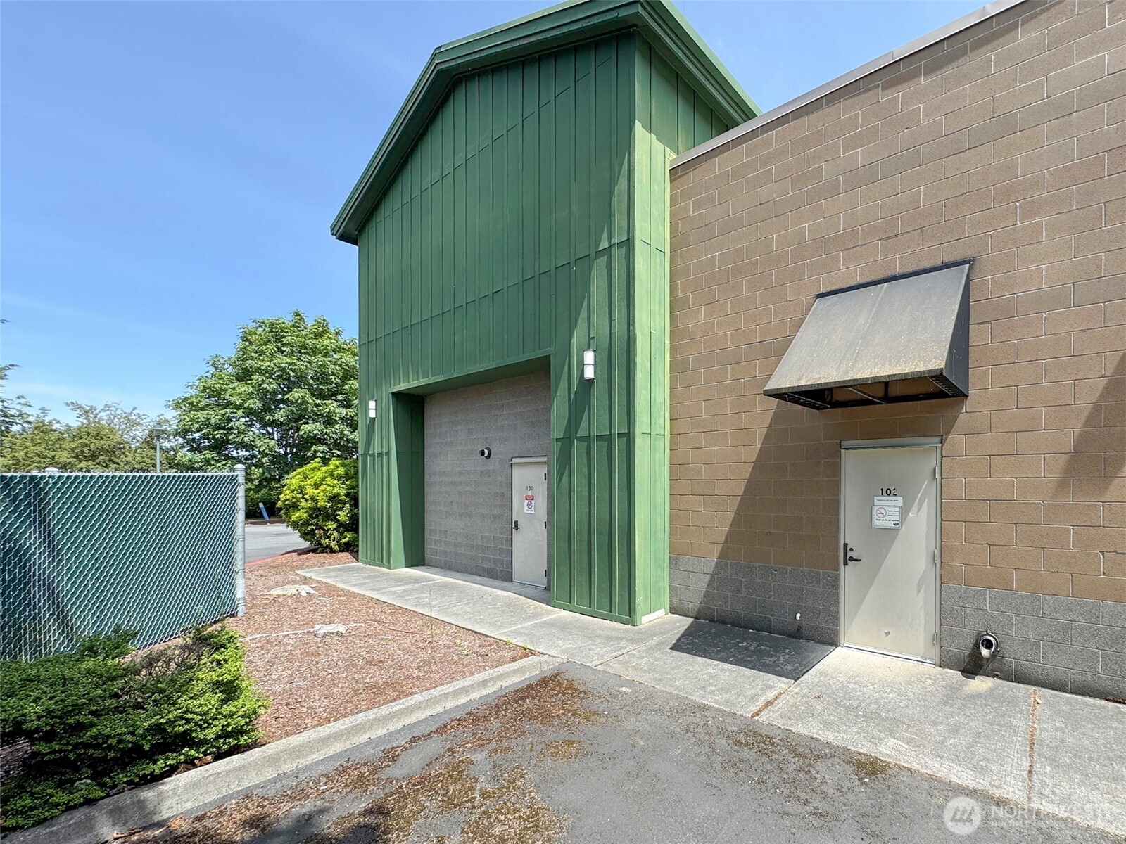1400 West Washington Street, Unit 102 Sequim, WA 98382 - Photo 30 of 35 a front view of a house with garage
