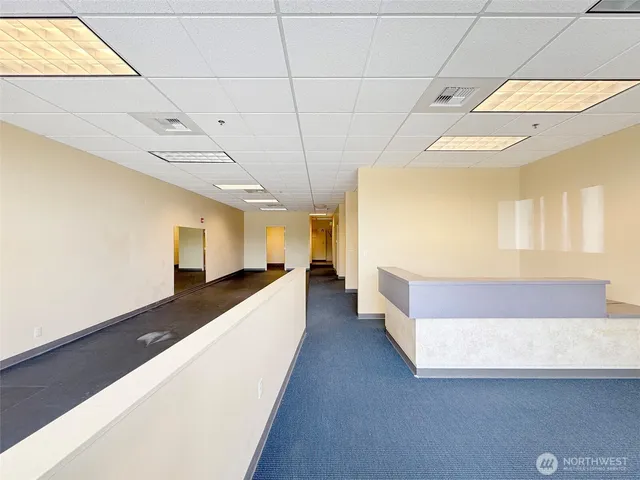 a view of a livingroom with an empty room and window