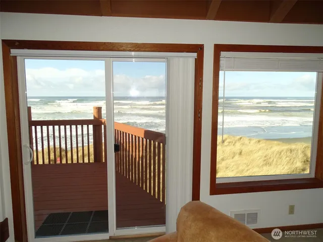 a dining room with furniture and a large window