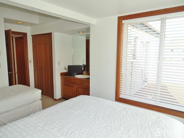 a bathroom with a sink mirror and toilet