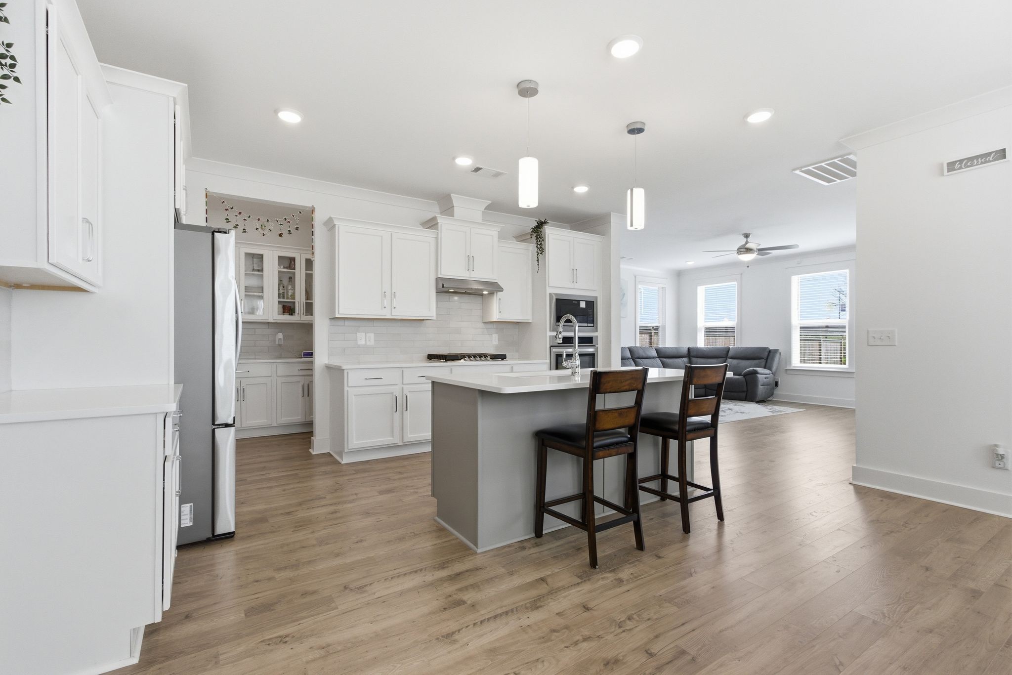 688 Conifer Drive Spring Hill, TN 37174 - Photo 9 of 40 a kitchen with a dining table chairs refrigerator and cabinets