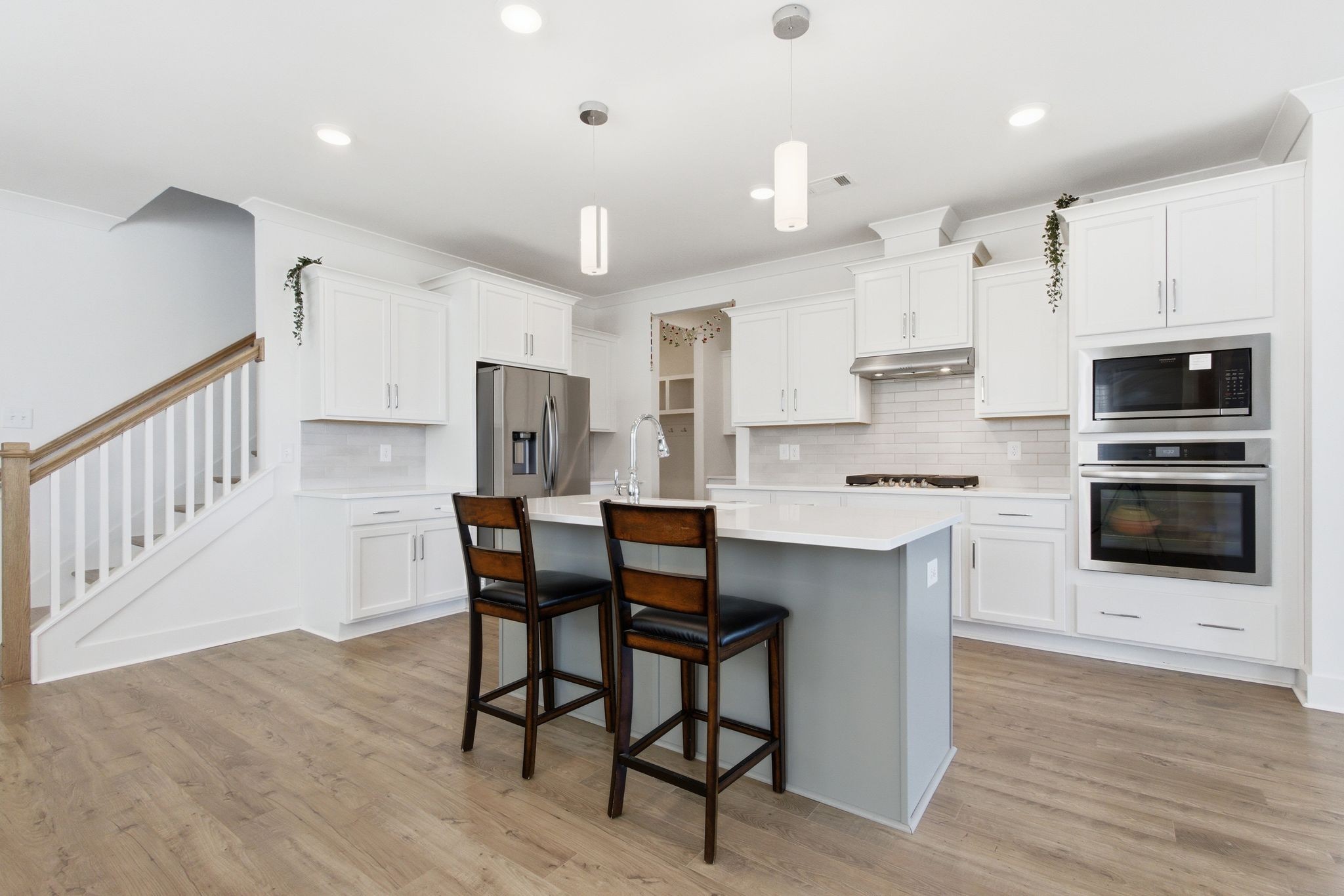 688 Conifer Drive Spring Hill, TN 37174 - Photo 10 of 40 a kitchen with stainless steel appliances a table chairs refrigerator and microwave