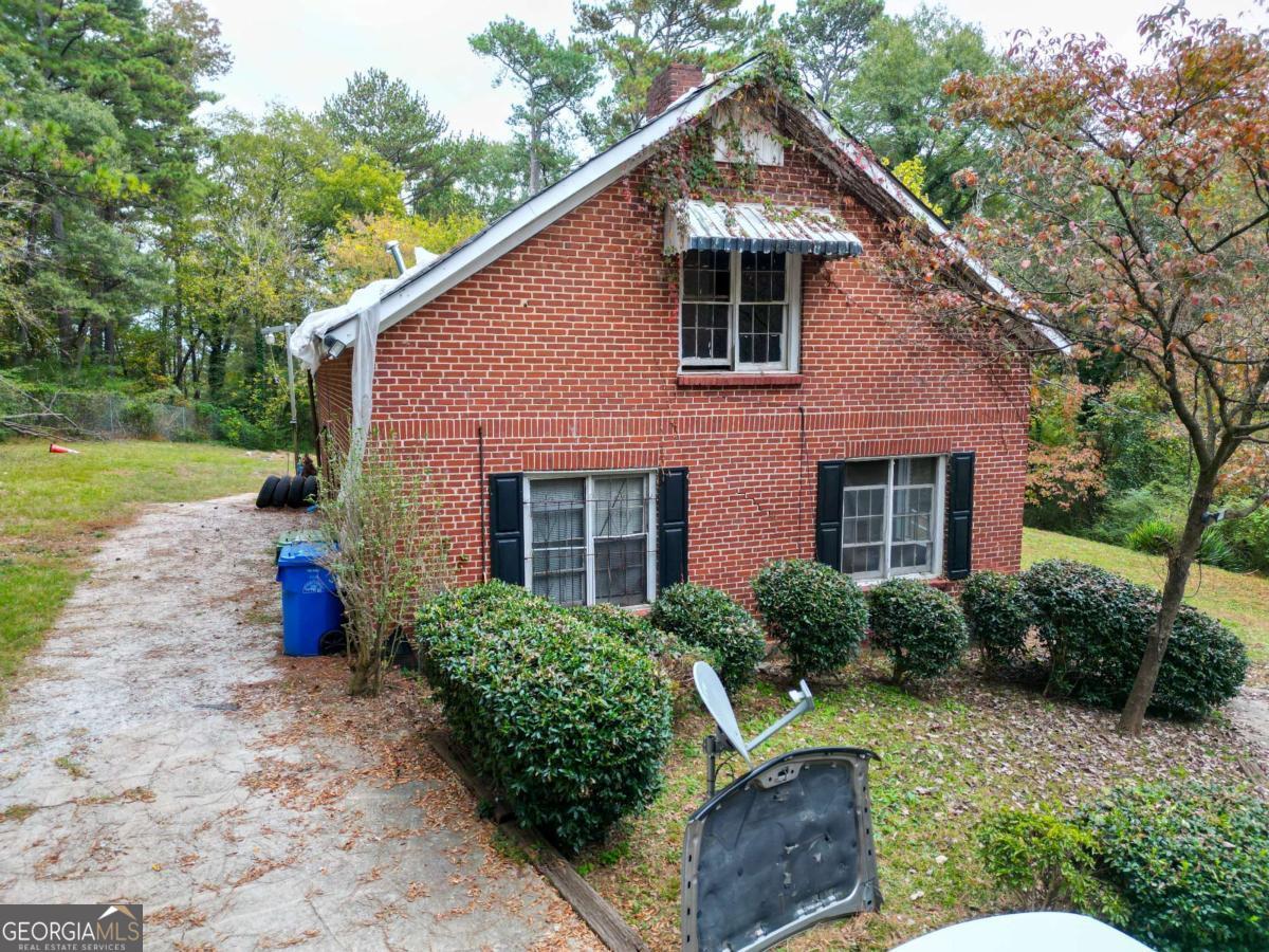 1345 Gun Club Road Northwest Atlanta, GA 30318 - Photo 9 of 12 a front view of a house with porch