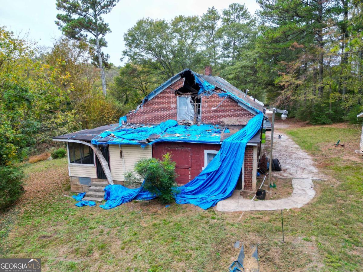 1345 Gun Club Road Northwest Atlanta, GA 30318 - Photo 10 of 12 a front view of a house with garden