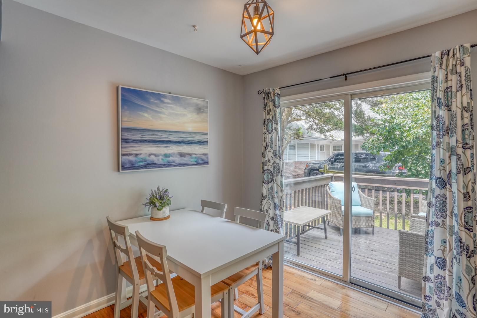 34527 Oakley Court, Unit 24 Lewes, DE 19958 - Photo 13 of 28 Dining area. Sliding glass doors to deck