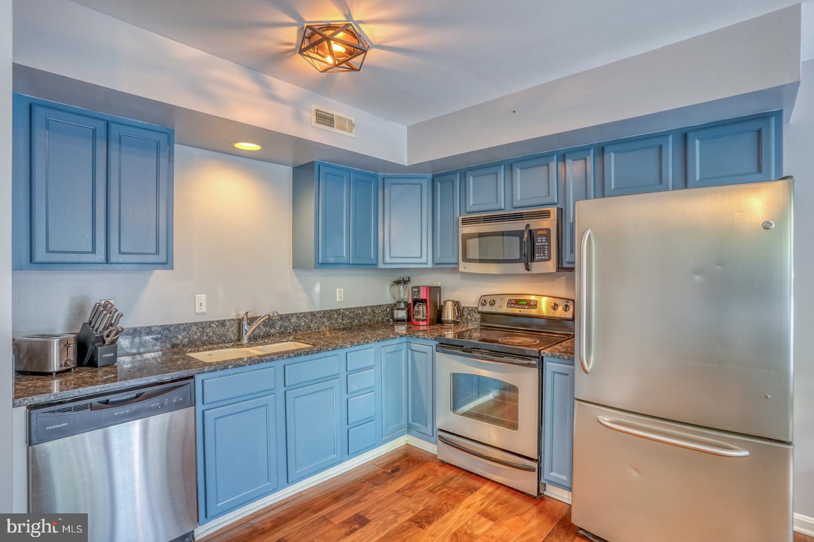 34527 Oakley Court, Unit 24 Lewes, DE 19958 - Photo 8 of 28 Kitchen with SS appliances and granite countertops