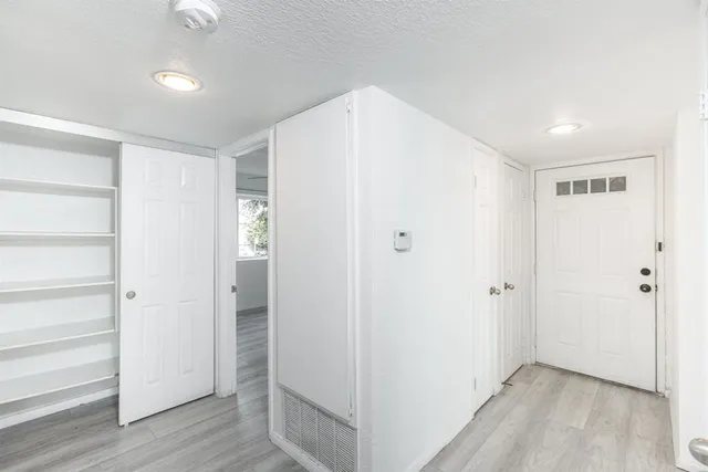 a view of hallway with wooden floor