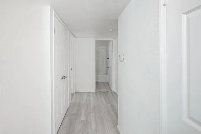 a view of a room with wooden floor
