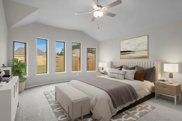 a bedroom with a large bed and a chandelier