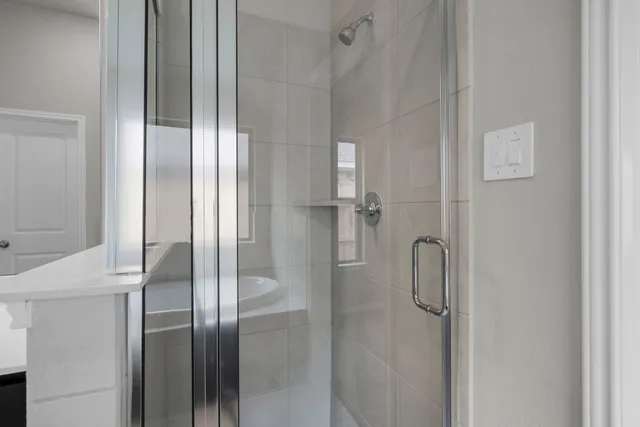 a bathroom with a glass shower door